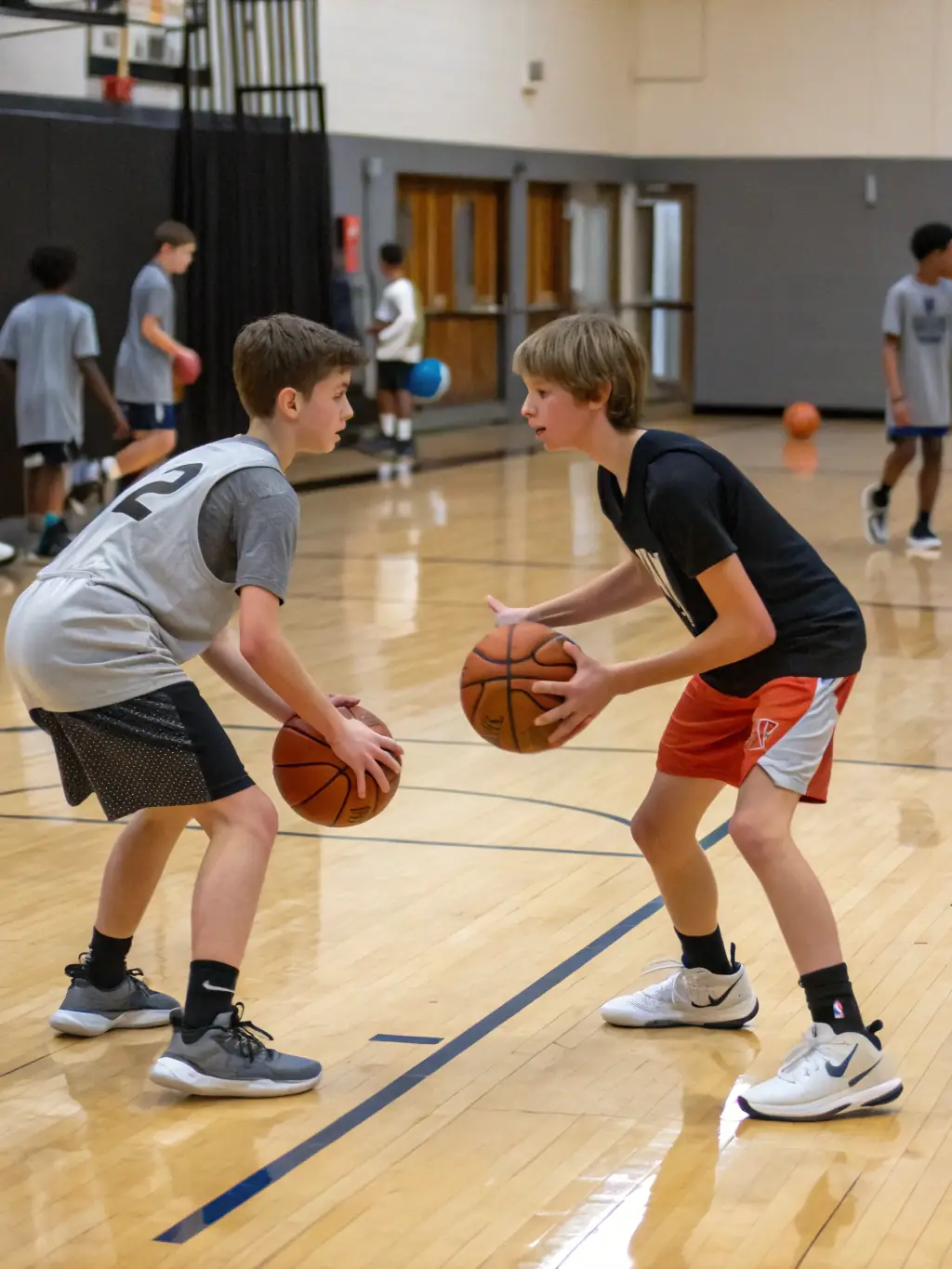 A group of young athletes dribbling basketballs during a practice session at LES GENETS UZERCHOIS, showcasing teamwork and skill development.