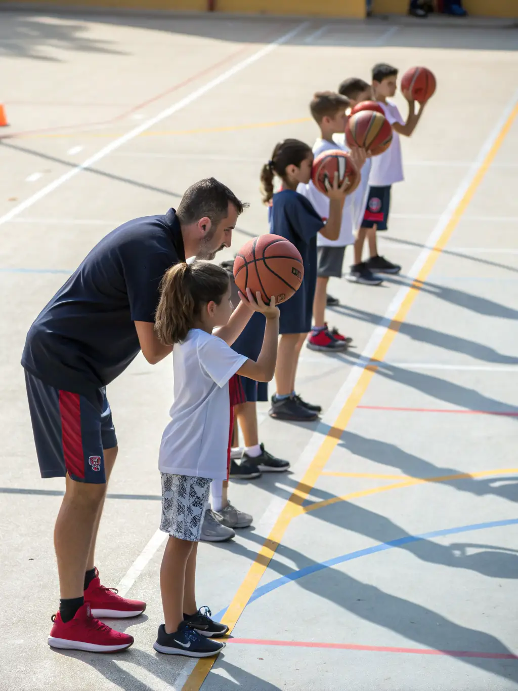 A LES GENETS UZERCHOIS coach is instructing young athletes on proper shooting techniques at a shooting range, highlighting the discipline required in sports.